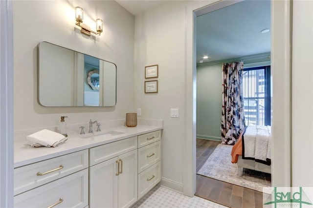 bathroom with hardwood / wood-style floors and vanity