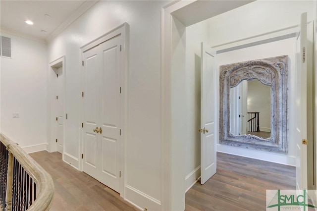 hall featuring wood-type flooring and ornamental molding