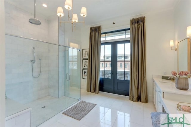 bathroom with french doors, an enclosed shower, ornamental molding, vanity, and an inviting chandelier