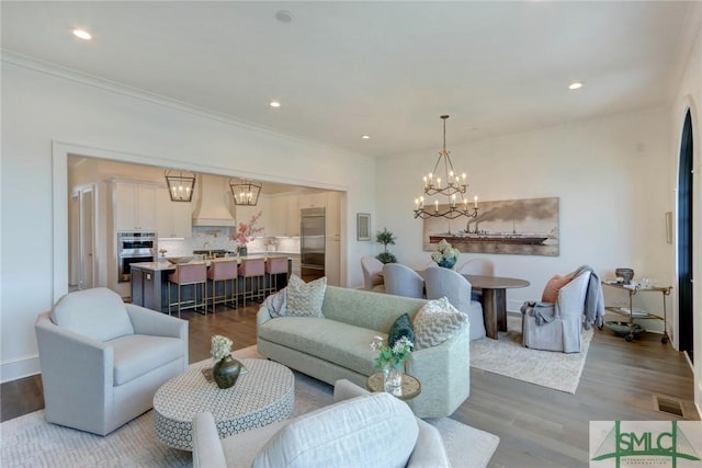 living room with wood-type flooring and ornamental molding