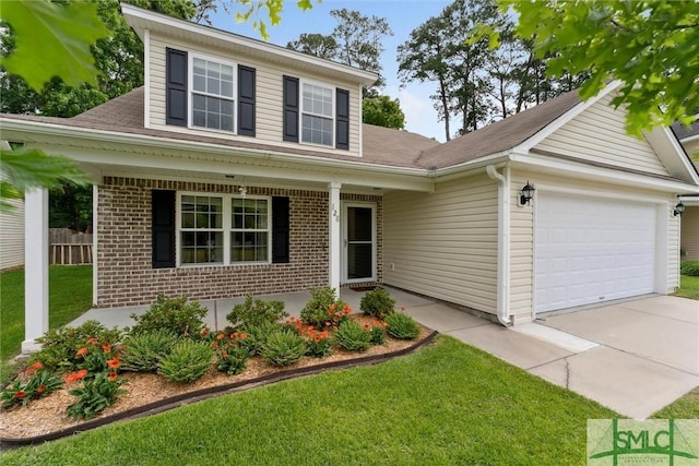 view of front of property featuring a front yard and a garage