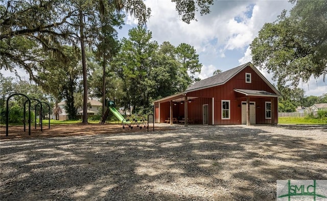 12 Cottonfield Dr, Guyton, GA 31312 - exterior space featuring a garage, an outbuilding, and a playground