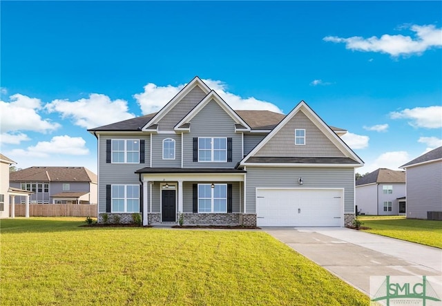 craftsman inspired home with a garage and a front lawn