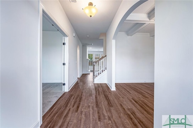 12 Cottonfield Dr, Guyton, GA 31312 - hallway featuring arched walkways, wood finished floors, stairs, and beamed ceiling