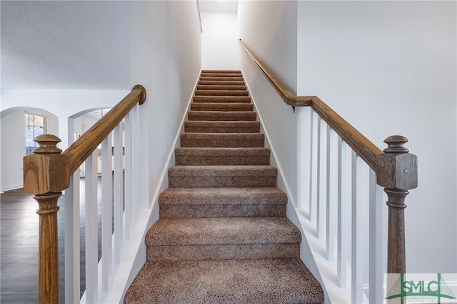 12 Cottonfield Dr, Guyton, GA 31312 - staircase with arched walkways and baseboards