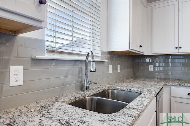 12 Cottonfield Dr, Guyton, GA 31312 - kitchen featuring backsplash, white cabinetry, and light stone counters