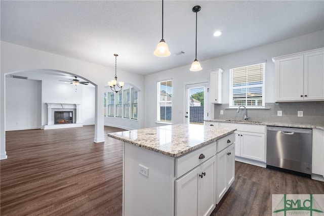12 Cottonfield Dr, Guyton, GA 31312 - kitchen with dishwasher, a glass covered fireplace, dark wood finished floors, a kitchen island, and tasteful backsplash