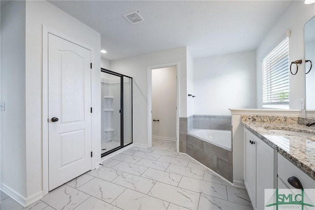 bathroom featuring shower with separate bathtub and vanity