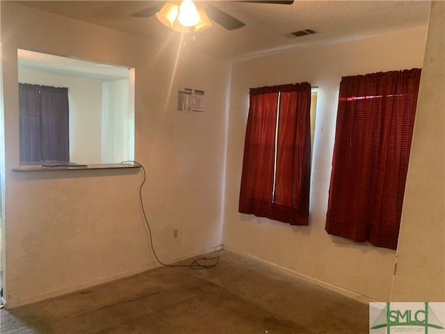 empty room featuring carpet floors and ceiling fan