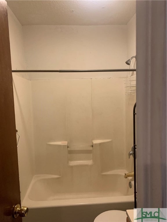 bathroom with toilet and shower / washtub combination