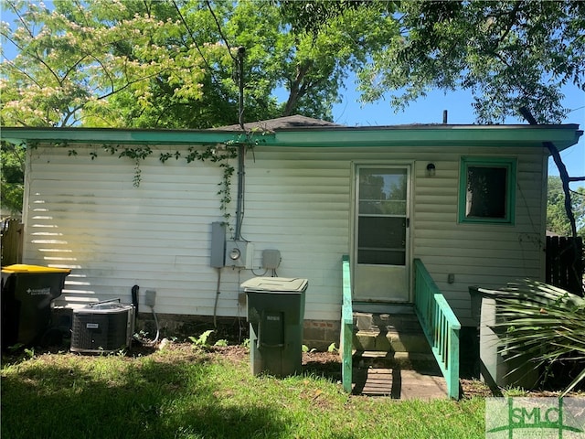 back of house with central air condition unit