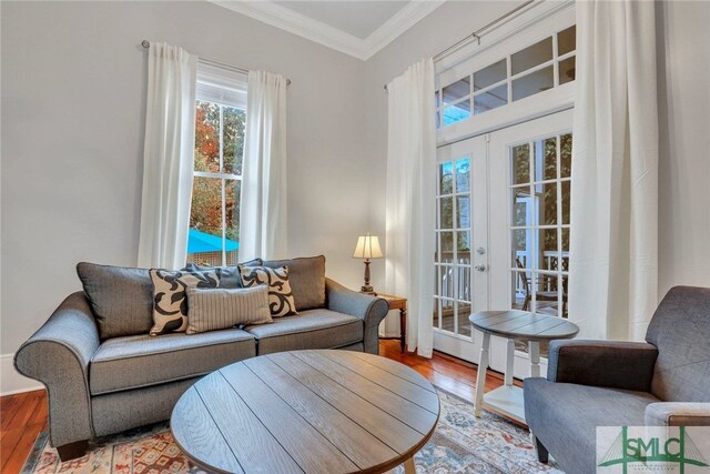 living room with french doors, ornamental molding, and wood-type flooring