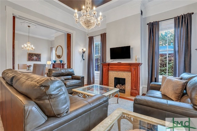 living room with an inviting chandelier and ornamental molding