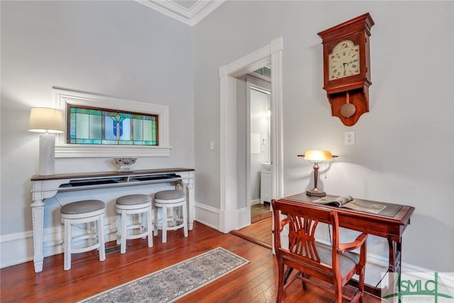 interior space featuring wood-type flooring and ornamental molding