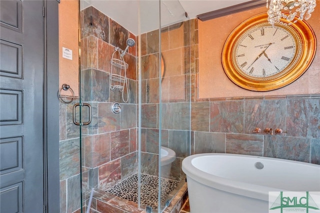 bathroom with separate shower and tub and tile walls