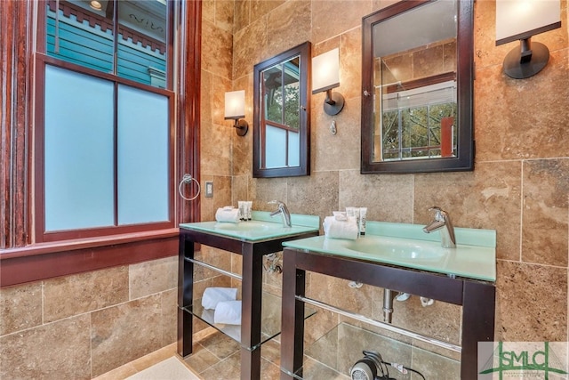 bathroom with vanity and tile walls