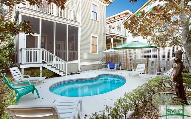 view of pool with a patio and a sunroom