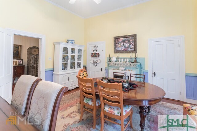 dining area featuring ornamental molding and wood-type flooring