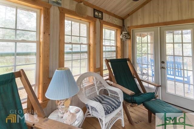 sunroom / solarium with french doors and lofted ceiling