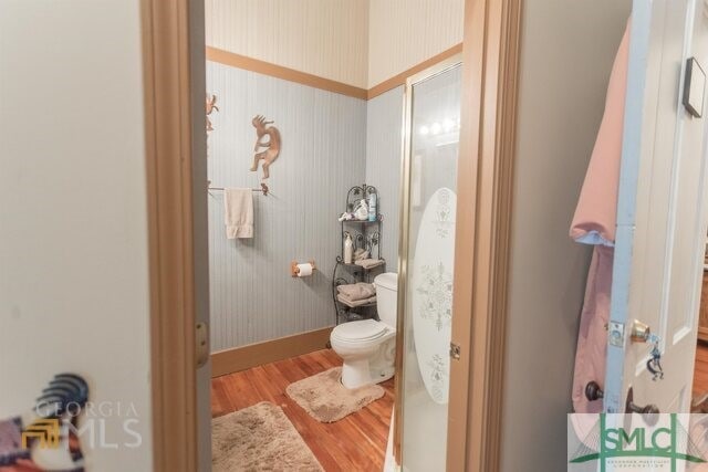 bathroom featuring wood-type flooring and toilet