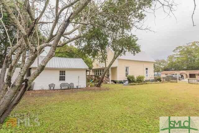 rear view of house with a yard