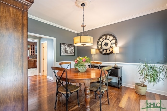 dining space with crown molding and wood-type flooring