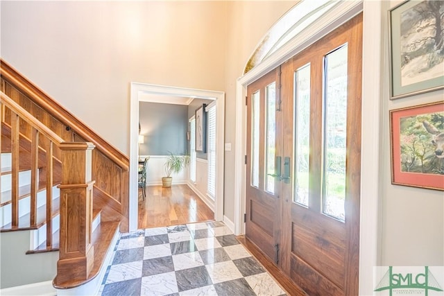 foyer entrance featuring wood-type flooring and french doors