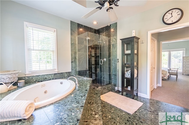 bathroom featuring ceiling fan, shower with separate bathtub, and a wealth of natural light