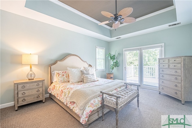 carpeted bedroom featuring a raised ceiling, ceiling fan, access to exterior, and ornamental molding