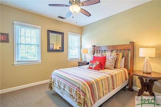 bedroom with ceiling fan, carpet floors, and multiple windows