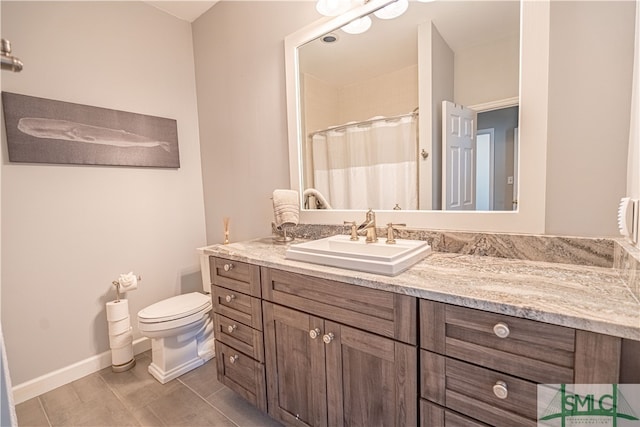 bathroom with tile patterned floors, vanity, and toilet