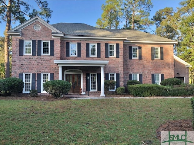 colonial home with a front lawn