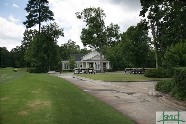 view of home's community with a yard