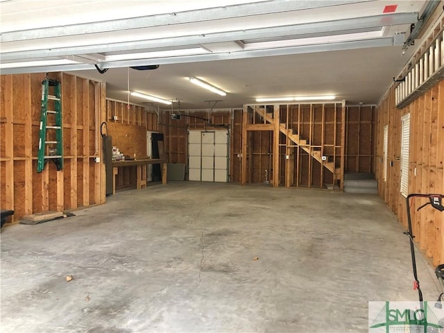 garage featuring wood walls and a garage door opener