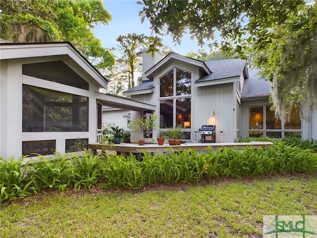 view of front of property with a front lawn and a sunroom