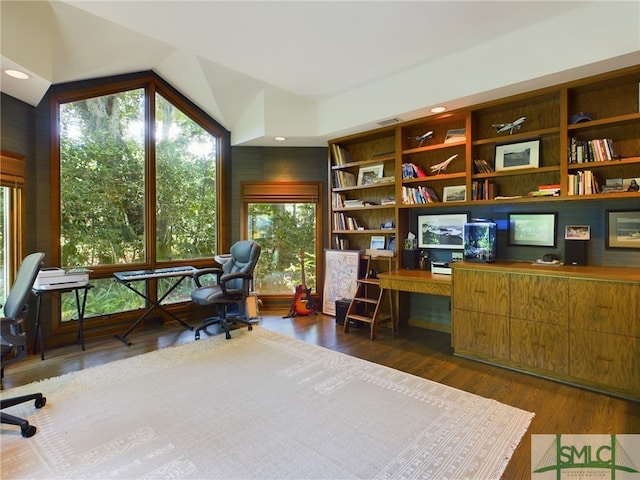 office with dark wood-type flooring and vaulted ceiling