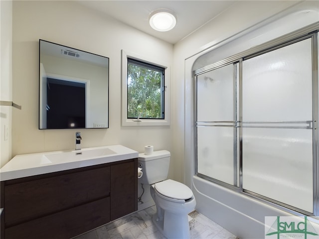 full bathroom with vanity, shower / bath combination with glass door, and toilet