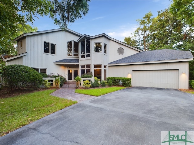 view of front of property featuring a garage and a front lawn