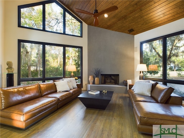 living room featuring high vaulted ceiling, a fireplace, wood-type flooring, ceiling fan, and wood ceiling