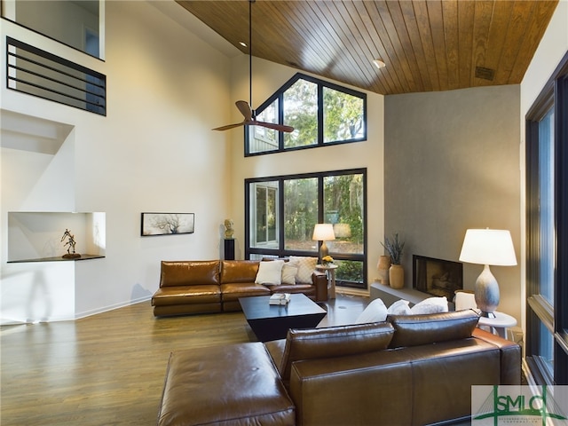 living room with wood-type flooring, high vaulted ceiling, wooden ceiling, and ceiling fan