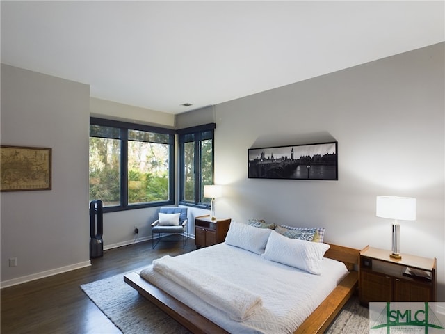 bedroom with dark wood-type flooring