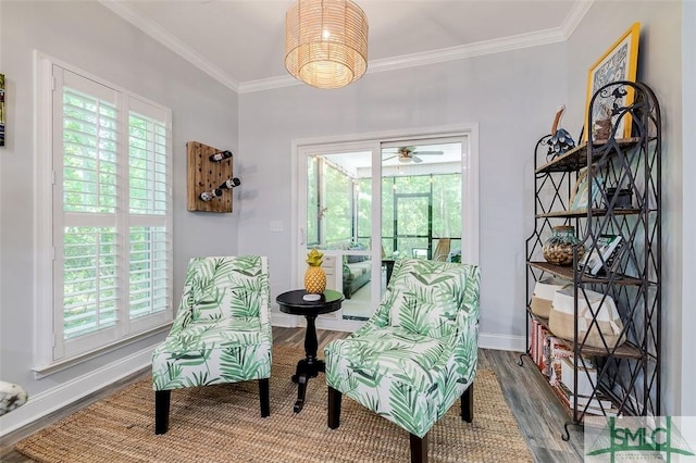 living area with ceiling fan, wood-type flooring, and ornamental molding