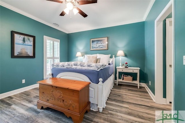 bedroom with hardwood / wood-style flooring, ceiling fan, and ornamental molding