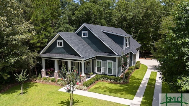 exterior space with covered porch and a yard