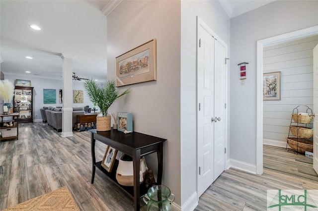 hallway with hardwood / wood-style floors and ornamental molding