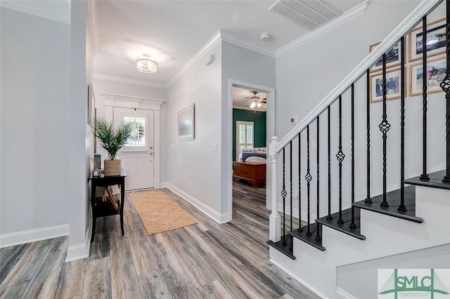 entrance foyer featuring ceiling fan, hardwood / wood-style floors, and ornamental molding