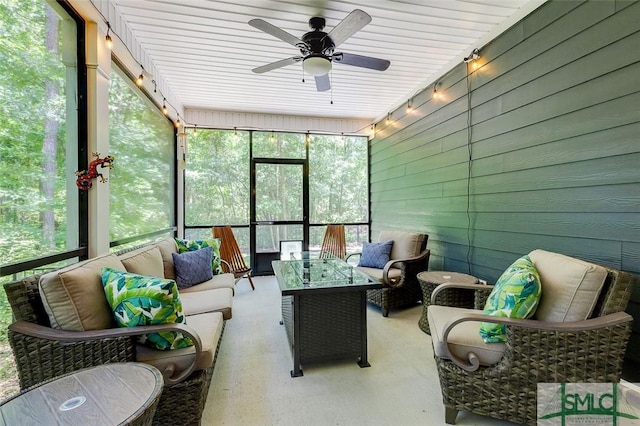 sunroom / solarium featuring ceiling fan