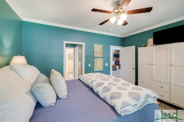 bedroom featuring ceiling fan, crown molding, and hardwood / wood-style floors