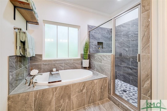 bathroom with ornamental molding and shower with separate bathtub