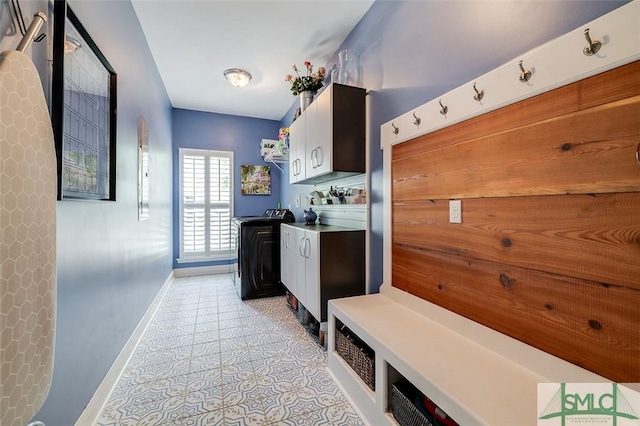 mudroom with washing machine and dryer and light tile patterned flooring